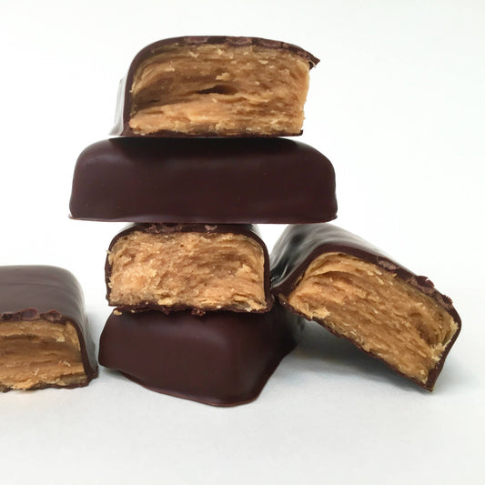 Cut Tom Bumble Smooth Candy Bar showing flaky peanut butter and chocolate layers