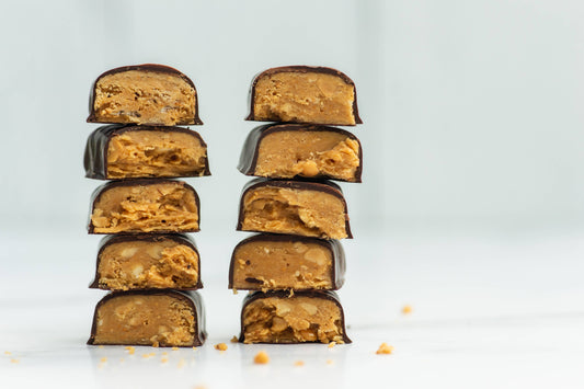 Stack of Tom Bumble Nutty Bars showing flaky peanut butter & chocolate layers
